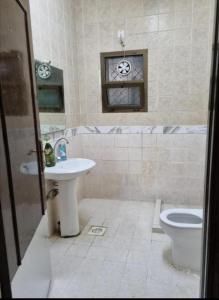 a bathroom with a sink and a toilet at Budget Hostel Rooms in Al Ain