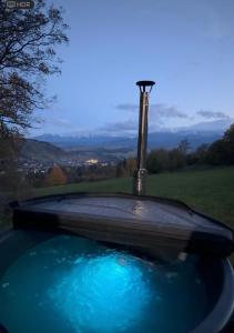 a hot tub with a fountain in a yard at Chata na Grapie in Biały Dunajec