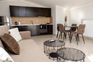 a living room with a couch and a table at HOME WITH VIEW in Xanthi