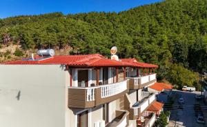 a building with a red roof and a mountain at HOME WITH VIEW in Xanthi
