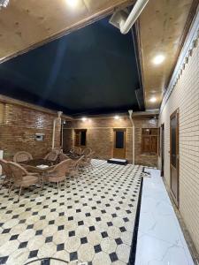 a room with a table and chairs and a ceiling at Shahina in Samarkand +19 photos
