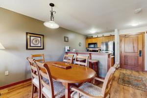 a kitchen and dining room with a wooden table and chairs at Eagle Springs East 402: Buffaloberry Suite in Solitude