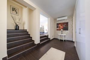 a hallway with stairs with a vase of flowers at My Dalmatia - Sea view Villa Bella with private heated pool and jacuzzi in Kokić