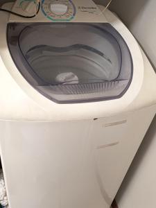 a white washing machine sitting on a counter at VIVA - Centro - Garagem - Apt 1 Dormitório in Santa Maria