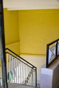a yellow wall with a staircase in a building at Mylon deluxe in Nakuru