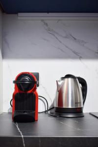 a tea pot and kettle on a kitchen counter at EmmeleiaLuxuryStudio in Xanthi