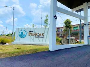 a sign for a pruitt new pharmacy at Townixi Stay in Kampong Jelatang
