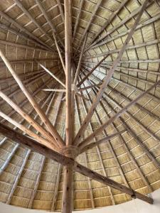 a large wooden ceiling of a thatched building at African-style villa with lake view, sleeps 12 in Rwamagana