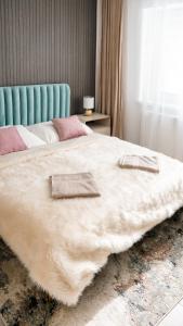 a large white bed with two pillows on it at Star house Sereď in Seredʼ
