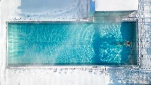 a pool of water with a person in it at Hotel Der Löwe LEBE FREI in Leogang