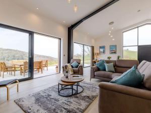 a living room with two couches and a table at 4 Bed in Berrynarbor 65786 in Berrynarbor