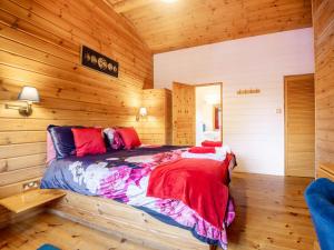 a bedroom with a bed in a wooden cabin at 1 Bed in Clovelly 00354 in Clovelly