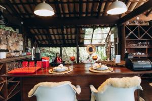 a restaurant with a table and two white chairs at Casas Lago Paranoá in Paranoá +80 photos