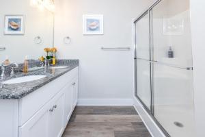a bathroom with a shower and a sink at 525 The Back Bay House in Virginia Beach +42 photos