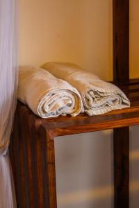 twee dekens liggen op een houten tafel bij Ella Mc Queen Homestay in Ella
