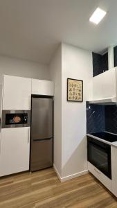 a kitchen with a refrigerator and a stove at Villaverde New Home in Madrid