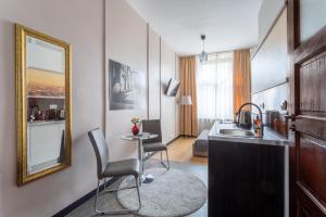 a bathroom with a sink and a mirror at Apartamenty Długa 27 in Kraków