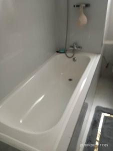 a white bath tub in a white bathroom at Napsa Complex B01 in Lusaka