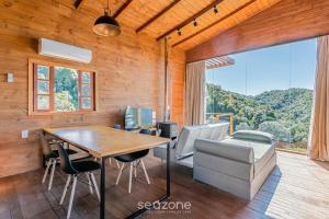 a dining room with a table and chairs at Cabana com vista Serra Catarinense VST023 in São Paulo dos Pinhais