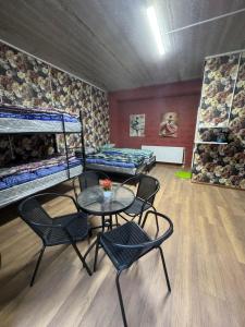 a room with a table and chairs and bunk beds at Villa Palma in Tbilisi City