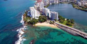 an aerial view of a beach with buildings and the ocean at Center of everything, art, beach and culture in santurce in San Juan