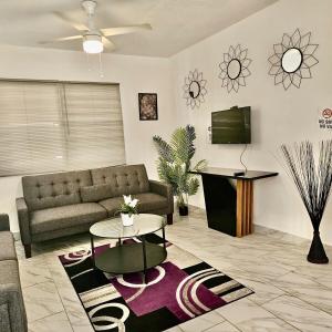 a living room with a couch and a tv at Center of everything, art, beach and culture in santurce in San Juan