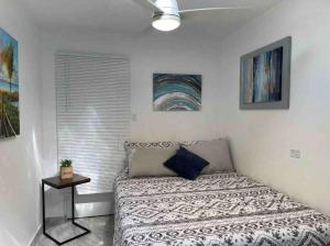 a small bedroom with a bed and a window at Center of everything, art, beach and culture in santurce in San Juan +49 photos