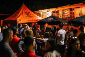 a crowd of people standing in a bar at night at Center of everything, art, beach and culture in santurce in San Juan