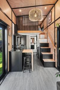 a kitchen and dining area of a tiny house at Tiny Home Escape w Sauna and Plunge in Whangarei