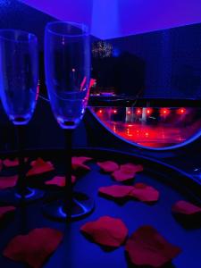 two wine glasses sitting on a table with hearts on it at MP Apartament 2 Białystok Jacuzzi in Białystok