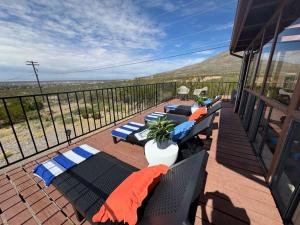 a deck with chairs and tables on a balcony at White Sands NP Retreat in Alamogordo