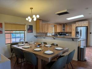 a kitchen with a large wooden table and chairs at White Sands NP Retreat in Alamogordo