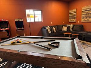 a living room with a pool table with three bats at White Sands NP Retreat in Alamogordo +9 photos