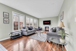 a living room with two couches and a tv at Luxury Mansion with Chefs Kitchen by Niagara Falls in Thorold