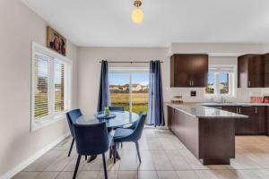 a kitchen and dining room with a table and chairs at Luxury Home Mins from Waterfall next to Transit in Niagara Falls