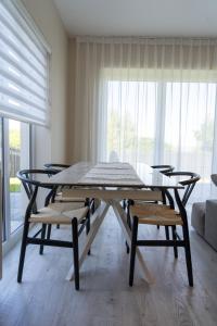 a table and chairs in a room with a large window at Ardlui House Gardens in High Blantyre