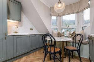 a kitchen with a table and chairs and a sink at Ledi Lookout Callander in Callander +35 photos