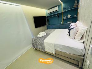a bedroom with a bed and a tv in it at Emunah Di Città Flats Ponta de Campina in Cabedelo +212 photos