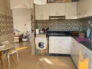 a kitchen with a washing machine in the middle at Apartment Private room in apartment in Khouribga in Khouribga
