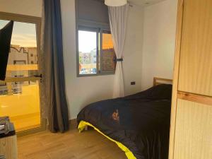 a bedroom with a bed and a window at Apartment Private room in apartment in Khouribga in Khouribga