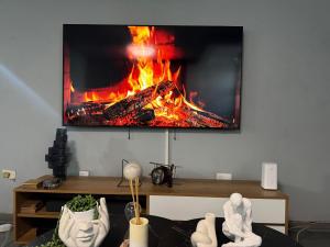 a living room with a fire on the wall at Davenport Durban in Durban