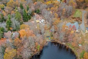 an aerial view of a house with a bridge over a lake at Long Pond Lakeside Kayaks Hot Tub Playground in Emerald Lakes