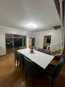 a dining table and chairs in a living room at Pousada Rota do Vale in Pomerode