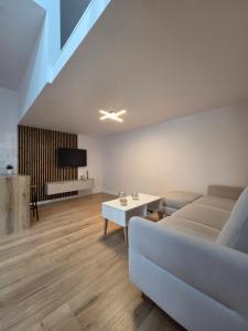 a living room with a couch and a table at Apartament Centrum in Kędzierzyn-Koźle