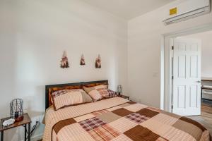 a bedroom with a bed and a white wall at Prescott Home Close to Hiking and Medical Centers! in Granite Dells