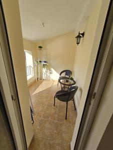 a hallway with a table and a chair in a room at Апартамент Венеция in Lovech