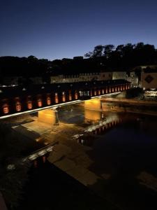 a bridge over a body of water at night at Апартамент Венеция in Lovech