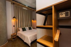 a small bedroom with a bed in a room at Hotel Boutique Obelisco in Medellín