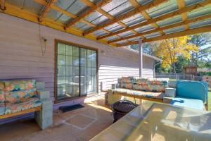 a patio with two chairs and a glass table at Playground and Grill Pet-Friendly Griffin Getaway! in Griffin