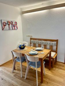 a wooden table with chairs and a dining room at Free living in Freistadt